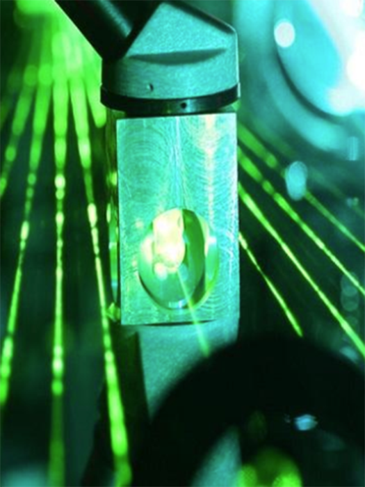 A green laser shining through instrumentation
